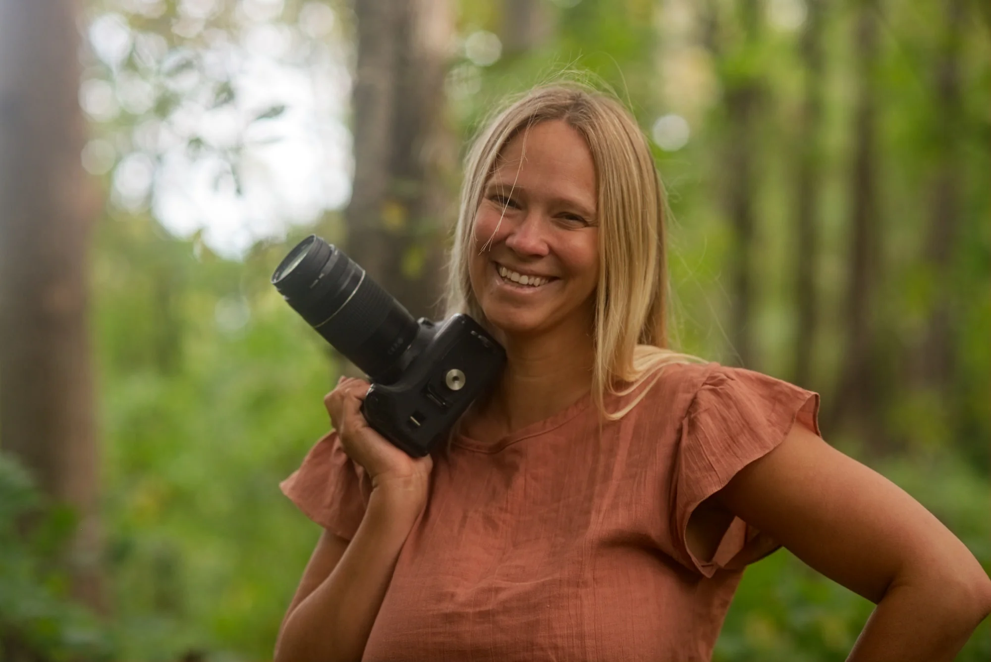 Steph Jensen with her camera in the woods outside Asheville